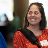 Two guests smile and laugh together in the lobby